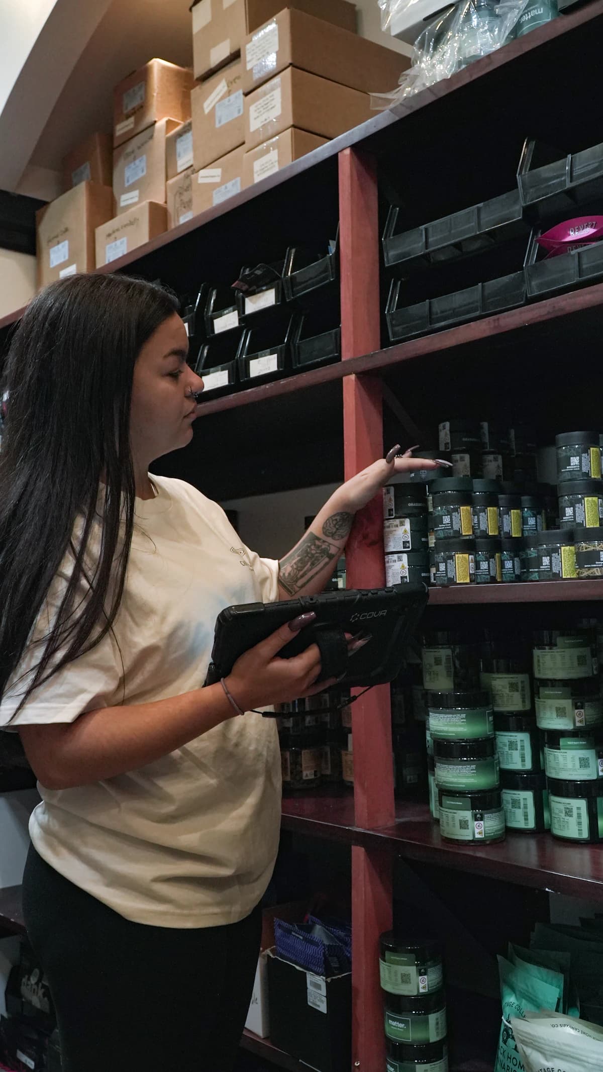 A team member checking inventory with a tablet